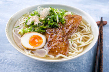 Modern style traditional Japanese ramen fish teriyaki soup with noudles and egg in a design bowl