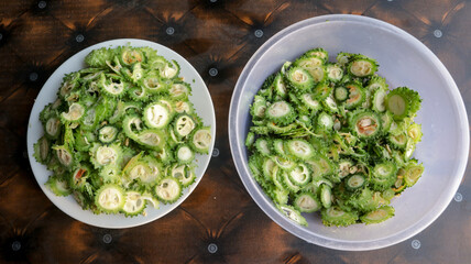 Green Chopped Bitter Gourd on two Plastic Pots top view