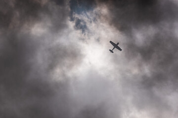 Airmanship. Aerobatics on an old Soviet plane from the Second World War in the sky with clouds and battle smoke.