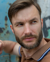 man looks to the side suspiciously and wary, close-up.