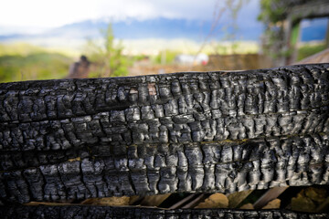 Shallow depth of field (selective focus) details with burned wood from a burnt house.
