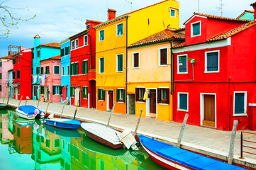 Colorful houses on the canal in Burano island, Venice, Italy. Famous travel destination.