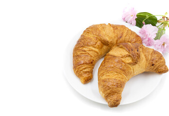 Croissants on a white plate. Top view. Space for the text.