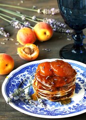 pancakes with jam slices of apricot with lavender. copy space, space for text