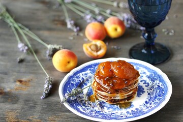 pancakes with jam slices of apricot with lavender. copy space, space for text