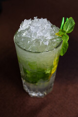 cold green cocktail with ice and mint in the cafe