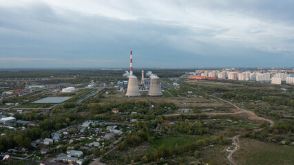 Fototapeta na wymiar Combined heat and power plant at sunset. in the neighborhood of the city. aerial view . General plan.