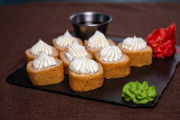 baked rolls with shrimp, sauce, ginger and wasabi