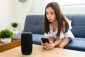 Child playing music on a smart speaker at home