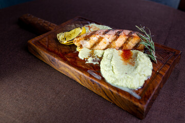 juicy fish steak with lemon and mashed potatoes. dish in the restaurant