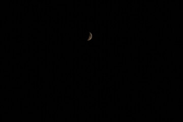 a crescent moon against a black sky