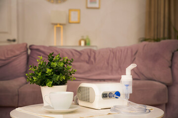 Nebulizer on the coffee table near the sofa in the room
