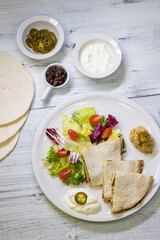 chicken quesadilla with rice, beans, salad, chalapenos and salsa