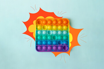 Top view of the new sensory toy - rainbow pop it with a painted explosion on sides like the sound...