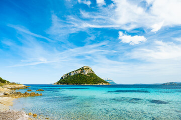 Sunning view of Figarolo island bathed by a turquoise water during a sunny day. Figarolo is an...