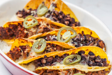 tacos filled with minced meat and black beans