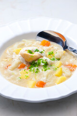 cauliflower soup with carrot, potatoes and poache egg