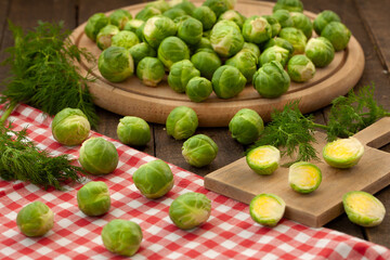 Fresh brussel sprouts on wooden board.. Green, healthy vegetables, vegan food.