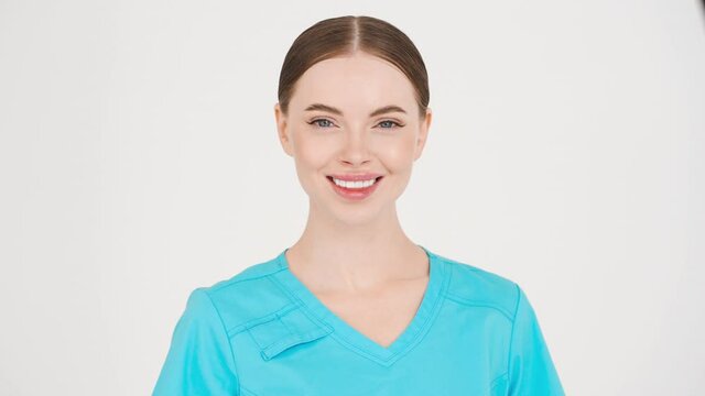 Medic woman doctor in blue professional uniformstudio face portrait happy teeth smile looking camera