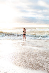 Fototapeta na wymiar Girl walking on the beach
