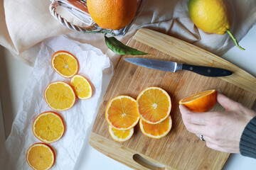 Obraz na płótnie Canvas Cut oranges lie on a wooden board, at home
