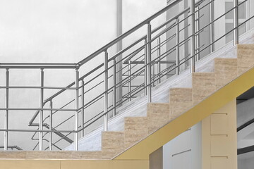 Modern Tiled Staircase Or Stairway With Stainless Steel Hand Railing At The Outside White Wall...