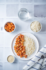 Sweet and sour chili sauce chicken with rice in a plate