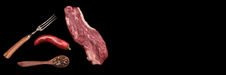 Raw Tenderloin Beef Steak or Skirt Steak and Spicy on Dark Black Stone Background, Closeup....