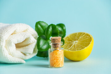 Organic cosmetics with lemon oil. Spa products on a blue background.