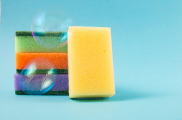 House cleaning: multi-colored dishwashing sponges with soap bubbles