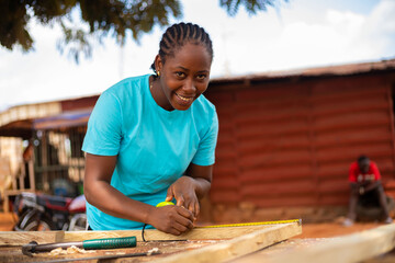 close up of a female professional carpenter taking measurement