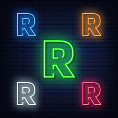 Neon letters, five colors: red, blue, green, yellow, white. Isolated font on a blue brick wall background. Vector illustration eps 10.