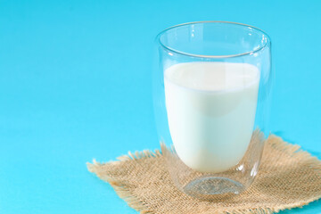 Glass of milk on a blue background. Milk products.