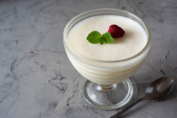 Vanilla Panna cotta in a beautiful cream bowl on a gray background
