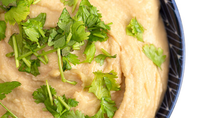 Bowl of Fresh Hummus on a White Background