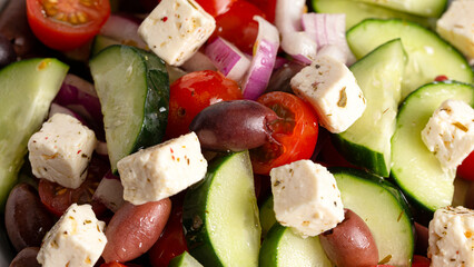 Bowl of Fresh Greek Salad with Cucumbers Tomatoes Olives and Feta Cheese