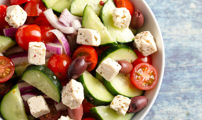 Bowl of Fresh Greek Salad with Cucumbers Tomatoes Olives and Feta Cheese