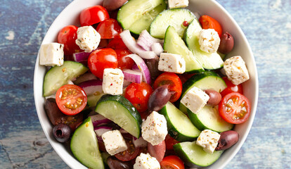 Bowl of Fresh Greek Salad with Cucumbers Tomatoes Olives and Feta Cheese