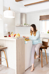 Vertical shot of a young girl preparing a healthy breakfast.