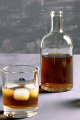 Alcohol. Bottle of whisky. A glass of scoth with ice. Copy space.
