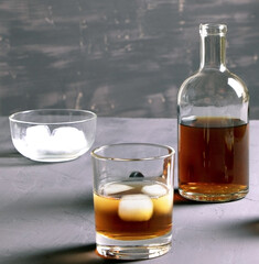 Alcohol. Bottle of whisky. A glass of scoth with ice. Copy space.