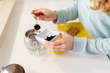 Hands of a girl preparing a tea. Healthy and breakfast concept.