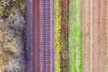 Romantic image of two railway tracks, two parallel steel rails, anchored perpendicular to members called ties (sleepers) of concrete to maintain a consistent distance apart, or rail gauge. - 434824717