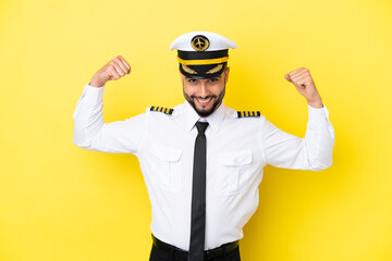 Airplane arab pilot man isolated on yellow background doing strong gesture