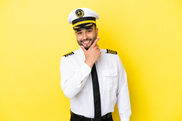 Airplane arab pilot man isolated on yellow background happy and smiling