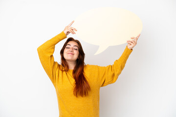 Young redhead woman isolated on white background holding an empty speech bubble