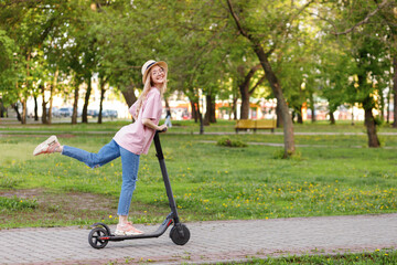 girl on an electronic scooter in a city park in the summer © BartLoveyou