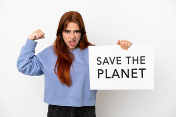 Young redhead woman isolated on white background holding a placard with text Save the Planet and doing strong gesture