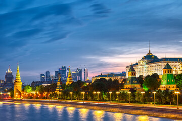 View of the Moscow Kremlin and Moscow City Skyscrapers along the quay of the Moscow river during evening sunset blue hour