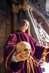 religius saint image holding a skull